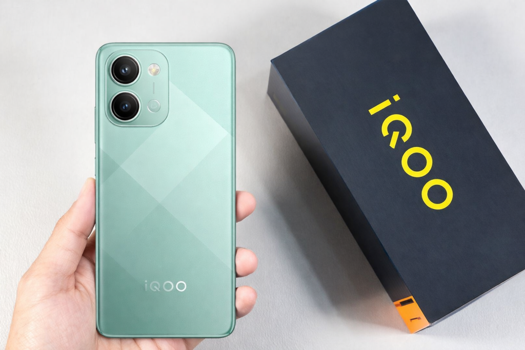 iQOO Z11x 5G green smartphone with dual camera design held in hand next to iQOO retail box